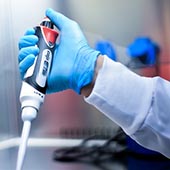 Scientist using a pipette