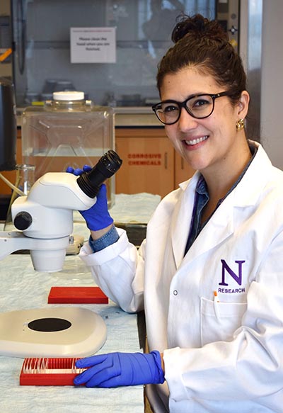 Zaida Alvarez poses with microscope